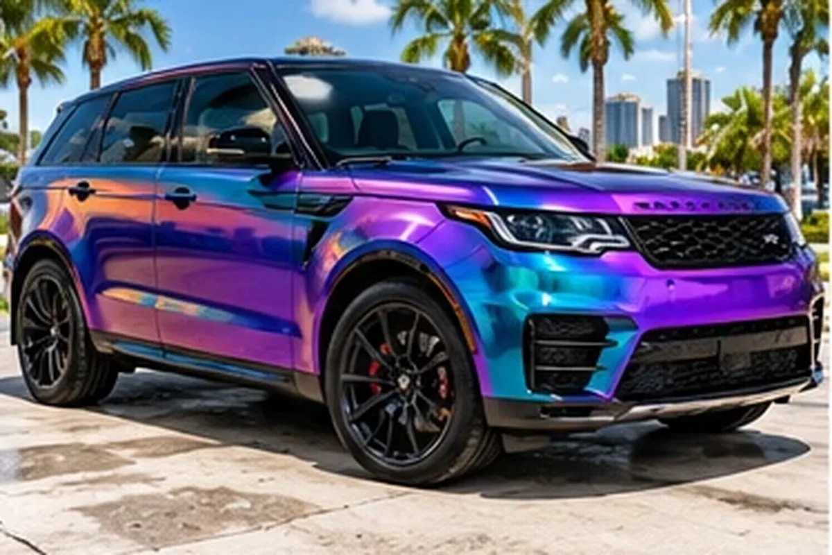 Color-shift purple and teal wrapped Range Rover with Los Angeles skyline